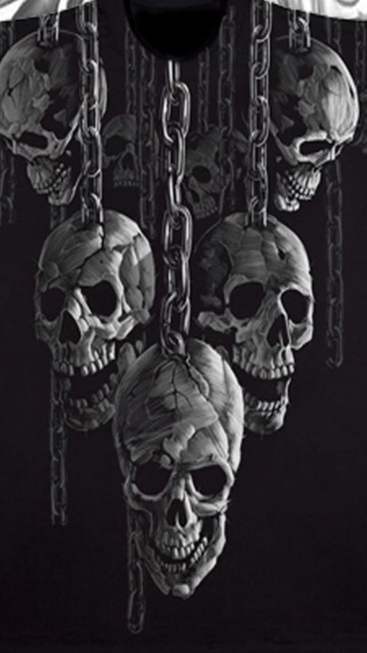 three skulls chained to chains on a black shirt