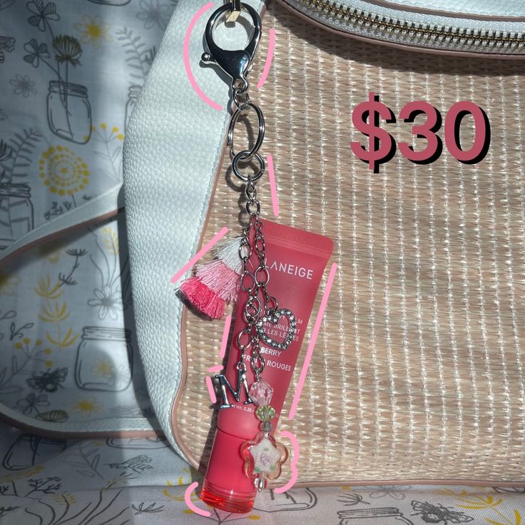 a purse with a keychain attached to it and a bag tag hanging from the front