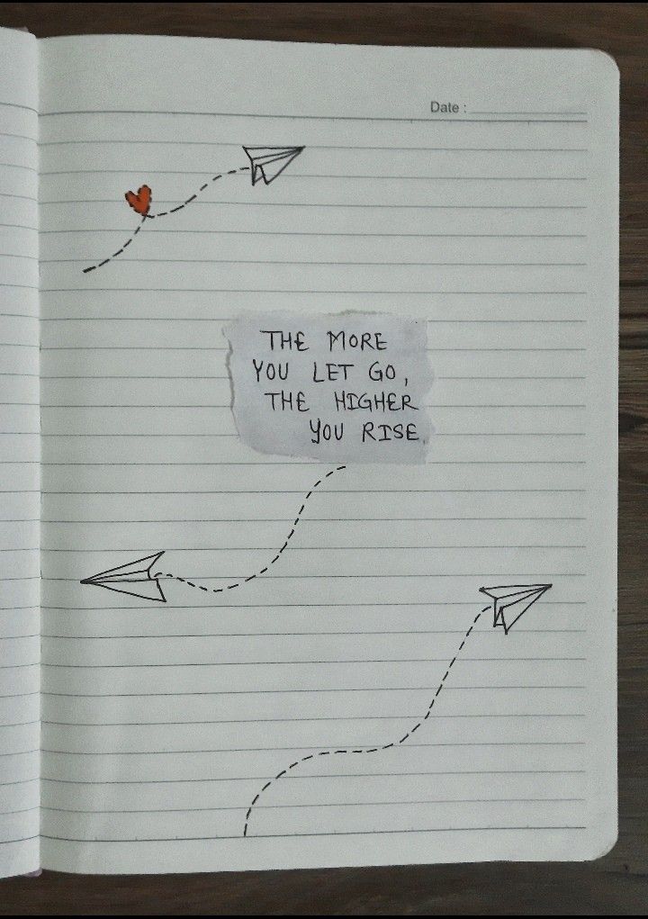 an open notebook with writing on it and paper airplanes flying in the sky, which reads'the more you let go the higher you rise '