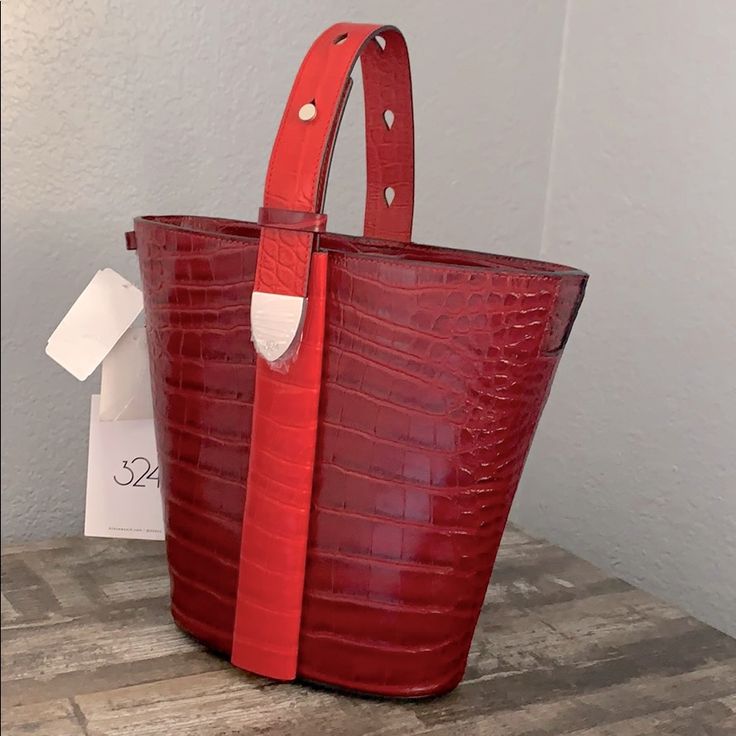 A Classic Anni-Croc Embossed Convertible Bucket Bag From 324 New York! Two Way Magnetic Closure And Adjustable Straps Allow You To Change The Look To Wear On Your Shoulder Or To Carry By The Top Handle. Enough Space For Essentials And Has Two Pockets Inside. 9"H 10.5w 4"D Let Me Know If You Have Any Questions. Red Bucket Bag With Top Carry Handle, Red Top Handle Bucket Bag For Evening, Red Bucket Shoulder Bag For Daily Use, Red Evening Bucket Bag With Top Handle, Everyday Red Bucket Bag With Top Carry Handle, Red Bucket Bag With Top Carry Handle For Shopping, Everyday Red Bucket Bag With Top Handle, Red Bucket Bag With Top Carry Handle For Everyday, Red Luxury Bucket Bag With Detachable Handle