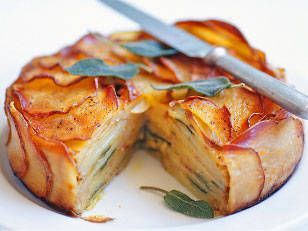 an apple pie is cut in half on a white plate with a knife and fork