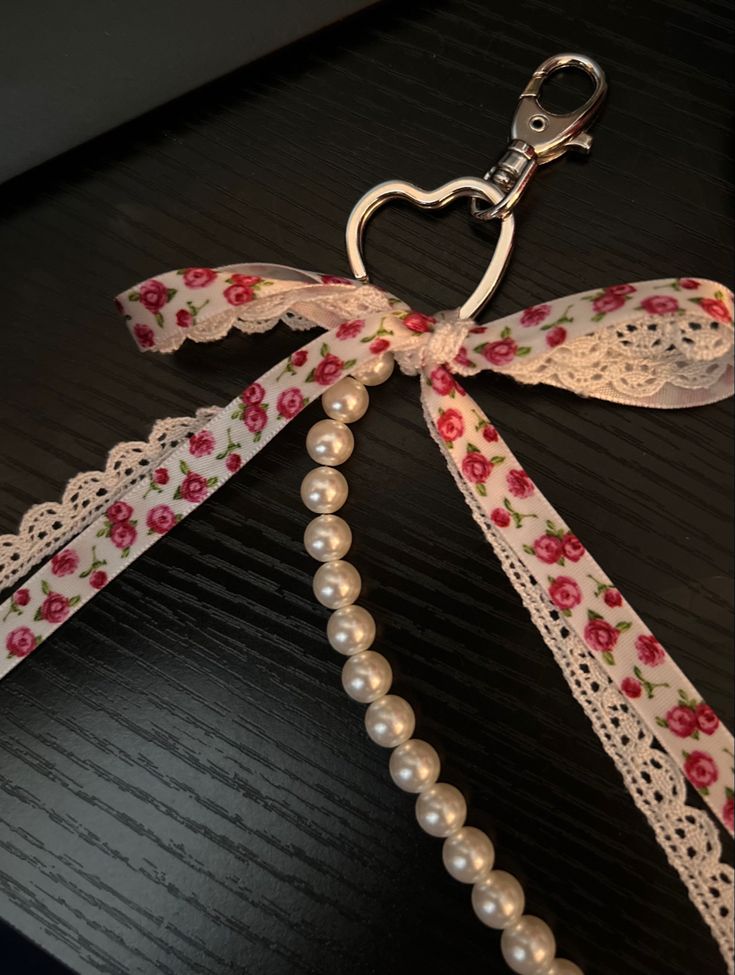 a key chain with flowers and pearls attached to it