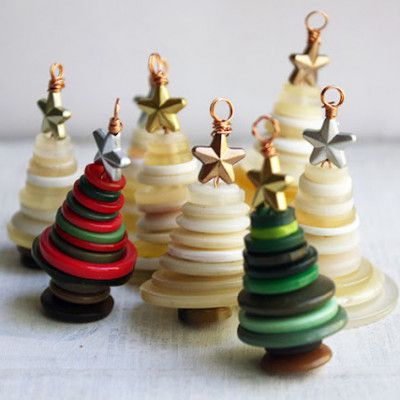 small wooden christmas trees are lined up on a table