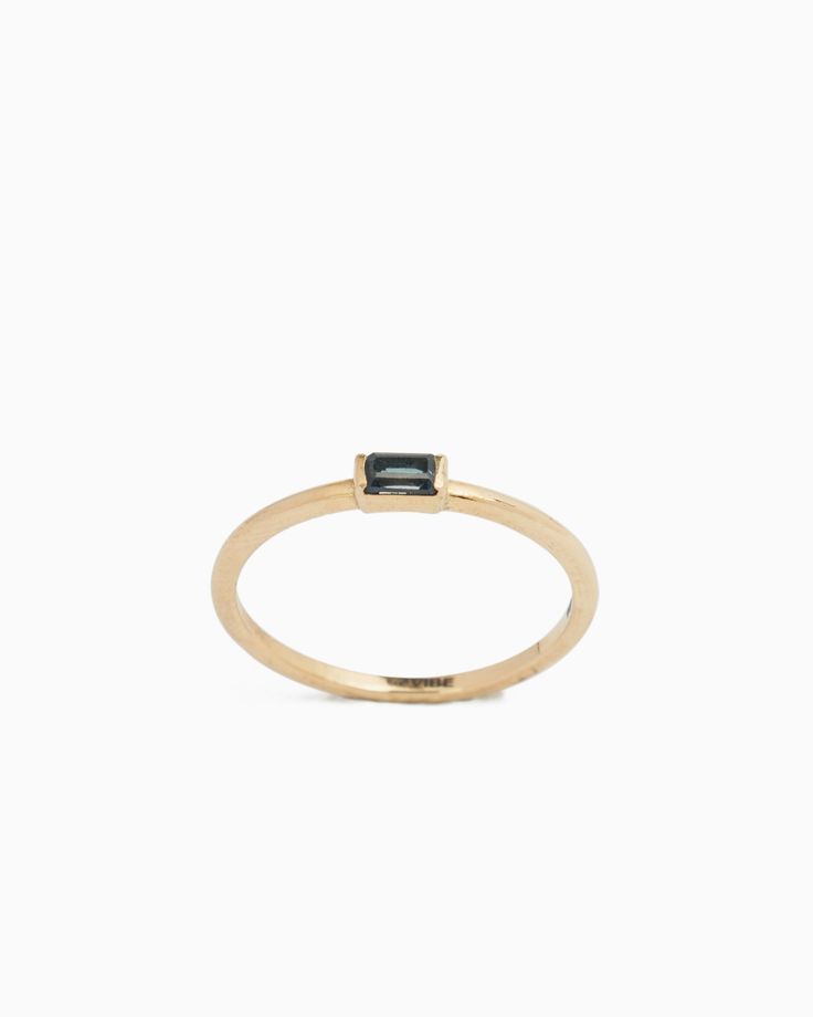 The Dainty Stacker Band, handcrafted in 14K solid gold, features a rectangular faceted London blue topaz stone. Whether worn solo for a minimalist look or stacked with other favorites, this ring adds a touch of elegance to your everyday jewelry collection. Metal: 14K solid gold Stone: London blue topaz Band Width: 1mm Stone Size: 4mm x 2mm Style #: GR169Lb Blue Topaz Stone, Topaz Stone, Gold Stone, London Blue Topaz, London Blue, Everyday Jewelry, Blue Topaz, Topaz, Solid Gold