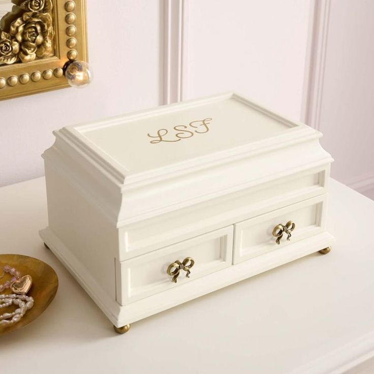 a white jewelry box sitting on top of a table