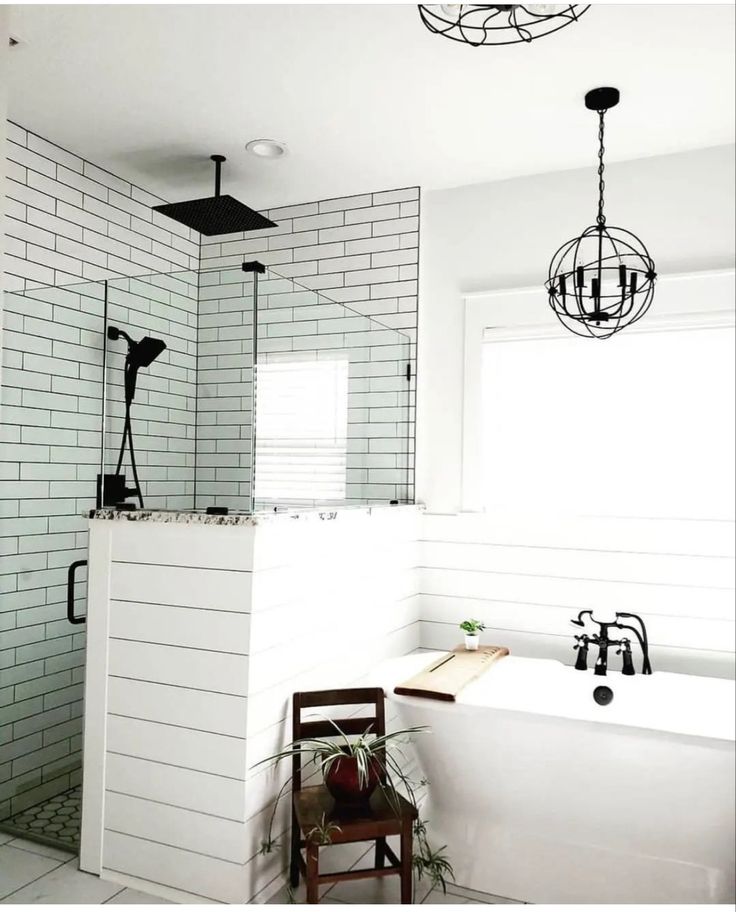 a bathroom with a bathtub, sink and shower head mounted to the side of the wall