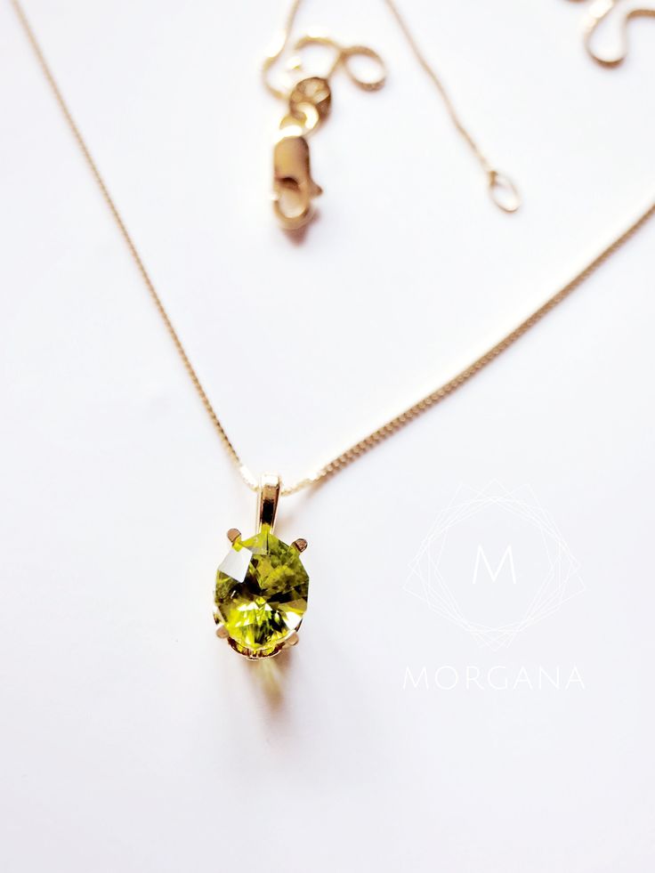 This captivating piece showcases a lustrous oval-cut natural peridot gemstone, radiating a deep green hue that captures the essence of nature's beauty. Set in a gleaming 18K gold pendant, the gemstone is gracefully suspended from a delicate chain, creating a harmonious balance between luxury and subtlety. The warm, rich tones of the 18K solid gold chain complement the gem's vibrancy, creating a harmonious blend of luxury and nature. Gemstone details: Dimensions: 8mm x 6mm (equivalent to a 1.25 carat diamond) Cut: oval/marquise mixed cut Color: deep olive green Clarity: SI1 Origin: Natural Peridot mined in Mesa, Arizona Custom Option:  - 8x6mm Oval birthstone or the gemstone of your choice Origin: Natural, mined. Oval Peridot Necklace For May Birthstone, Oval Green Peridot Necklaces, Green Oval Birthstone Necklaces, Green Oval Birthstone Necklace, Oval Peridot Birthstone Necklace, Lime Green Oval Jewelry For May Birthstone, Classic Lime Green Oval Jewelry, Oval Peridot Green Jewelry, Oval Green Peridot Jewelry