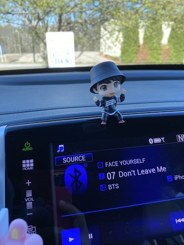 a toy is sitting on the dashboard of a car and it's display screen