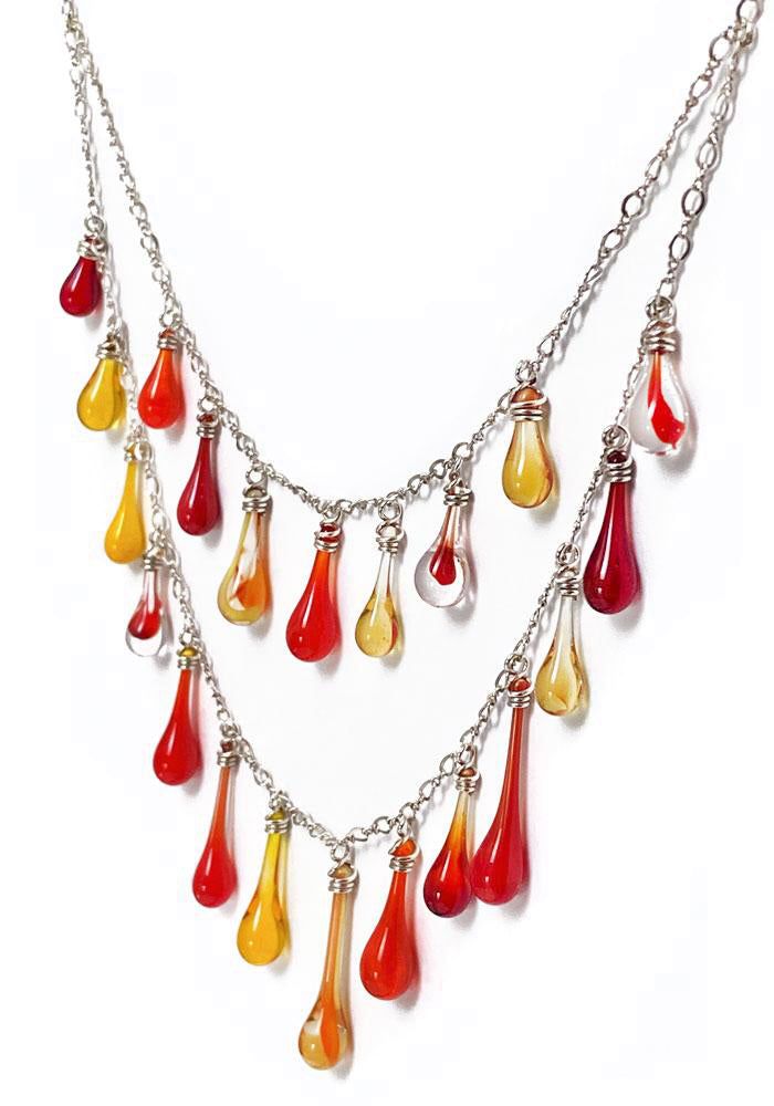 One-of-a-kind necklace, looking for a one-of-a-kind gal - could you be the one?? This necklace is dripping with an eclectic cascade of variegated glass droplets in reds, oranges and yellows. Top tier: 17" sterling silver chain (bottom tier 20") Additional 2.5" sterling silver chain extender, for the perfect position. Sterling silver findings are nickel-free and hypoallergenic Eco-friendly Lightweight and comfortable to wear Handcrafted in USA Sunshine in a drop of glass Each drop of glass is han Waterfall Necklace, Be The One, Recycled Bottles, Chain Extenders, Glass Earrings, Pretty Jewellery, Sterling Silver Chain, Top Tier, Earring Necklace