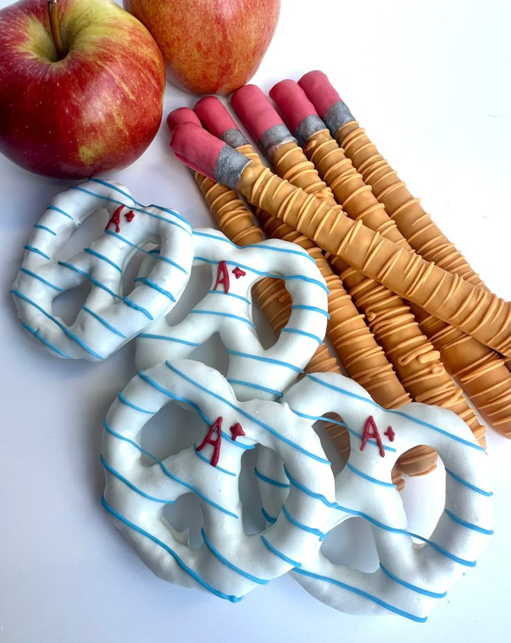 two apples, an apple and some other items on a white table with blue stripes