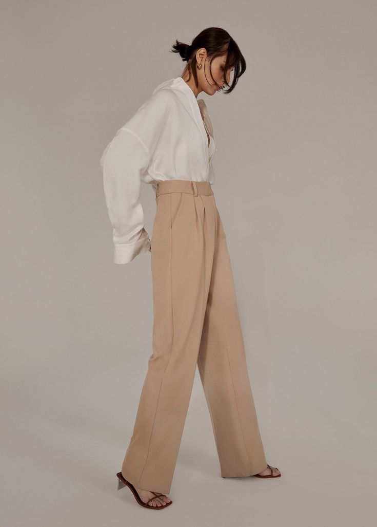 Everyone’s favorite. (Hence, the name.) These tailored, best-selling beauties have a fluid wide-leg silhouette with a high waist and front pleats. Crafted from a blend suiting fabric with front pockets and a relaxed fit, these beige trousers stand tall on their own but look especially sharp paired with the Favorite Blazer & coordinating vest.Inseam: 34"Rise: 12 3/4"69% Polyester, 26% Rayon, 5% SpandexModels are wearing size 2 and 8Inseam: 34" Chic Cream Bottoms With Pressed Crease, Wide Leg Cream Pants With Pressed Crease, Cream Wide-leg Pants With Pressed Crease, Beige Wide Leg Pants With Belt Loops, Chic Beige Wide Leg Dress Pants, Chic Beige Wide Leg Pants For Formal Occasions, Chic Beige Wide-leg Dress Pants, Chic Cream Wide Leg Pants For Formal Occasions, Tailored Cream Wide Leg Pants For Formal Occasions