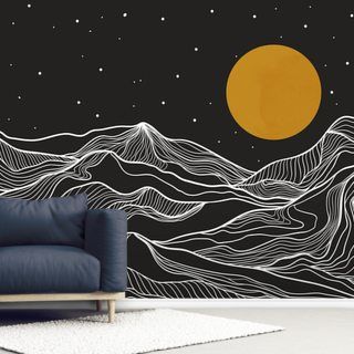 a living room with a couch, chair and wall mural