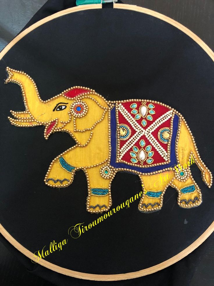 an embroidered elephant on a black background