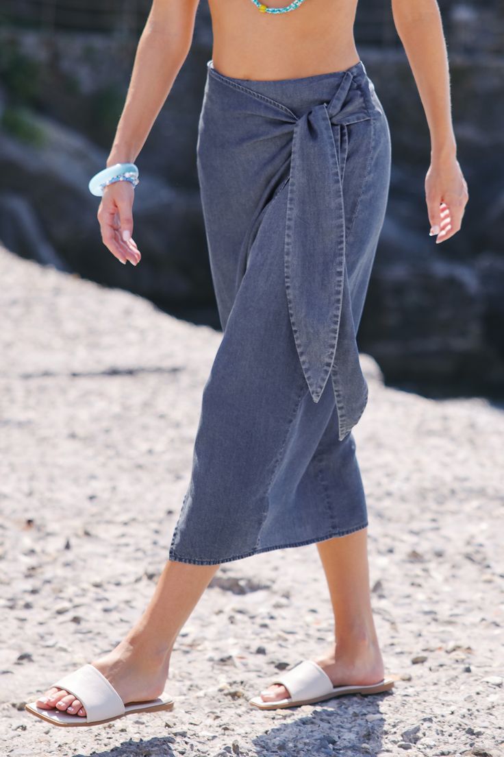 Wrap up in style with our Chambray Belted Wrap Skirt. This versatile piece features a trendy belt and wrap design, making it a must-have for casual yet polished looks. Product code: CAA02B4E012SS Features:  Woven Concealed zipper Self-tie sash belt  Wrap design Midi Material: 100%LYOCELL. Wrap Around Long Skirt, Chic Belted Beach Bottoms, Casual High Waist Skirt With Tie, Casual High Waist Skirt With Tie Waist, Versatile Belted Summer Bottoms, Versatile Summer Belted Bottoms, Versatile Belted Bottoms For Summer, Belted Skirt For Day Out, Casual High-waisted Skirt With Tie Waist