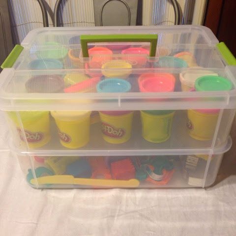 a plastic container filled with different colored cups