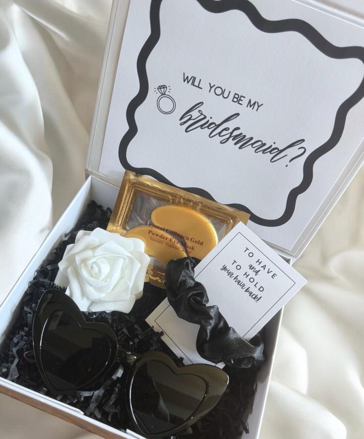 an open box containing sunglasses and a note that says will you be my bridesmaid?