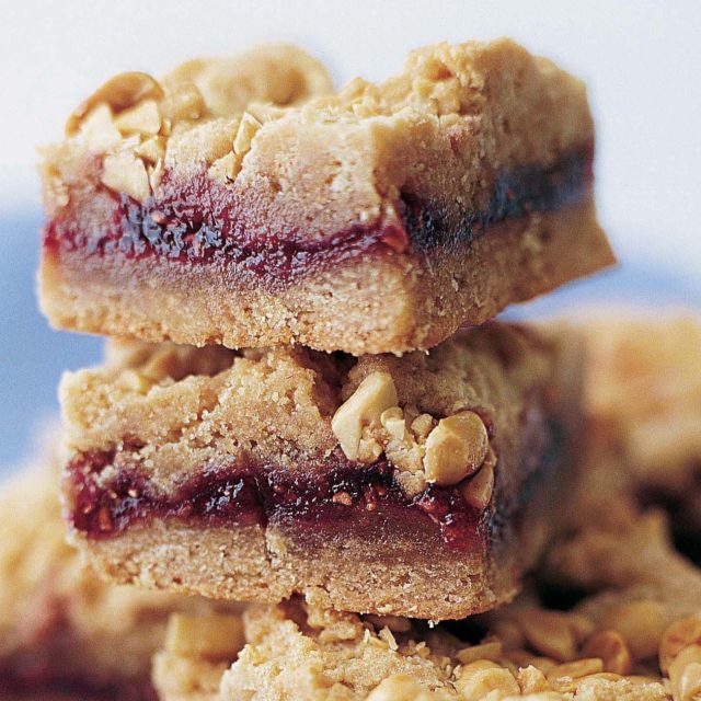 three cookies stacked on top of each other with jam in the middle and oatmeal toppings