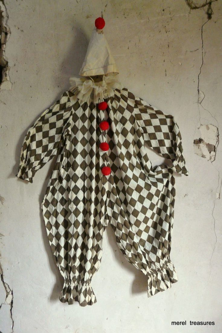 an old clown costume hanging on the wall