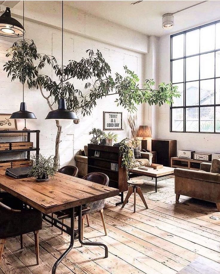 a living room filled with furniture and a tree in the middle of it's center