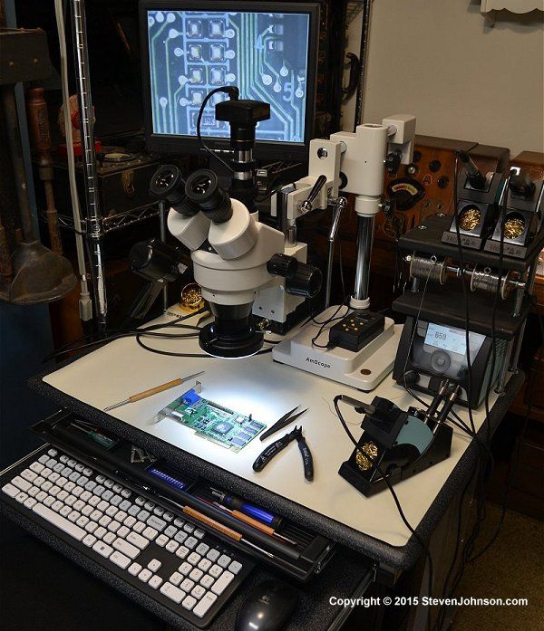 a microscope and some electronics on a table