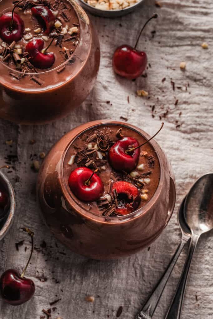 chocolate pudding with cherries and nuts in bowls