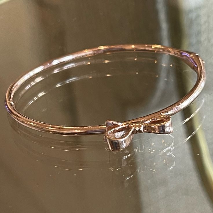 New Rose Gold Bangle Bracelet By Kate Spade. A Bow On The Top And A Box Tab Insert Clasp. Chic Rose Gold Jewelry With Bracelet Strap, Chic Rose Gold Bracelet For Gift, Feminine Rose Gold Metal Jewelry, Kate Spade Bangle Bracelet For Formal Occasions, Elegant Metal Bracelets By Kate Spade, Kate Spade Formal Bangle Bracelets, Kate Spade Elegant Bangle Jewelry, Adjustable Metal Bracelet By Kate Spade, Kate Spade Formal Bangle Bracelet