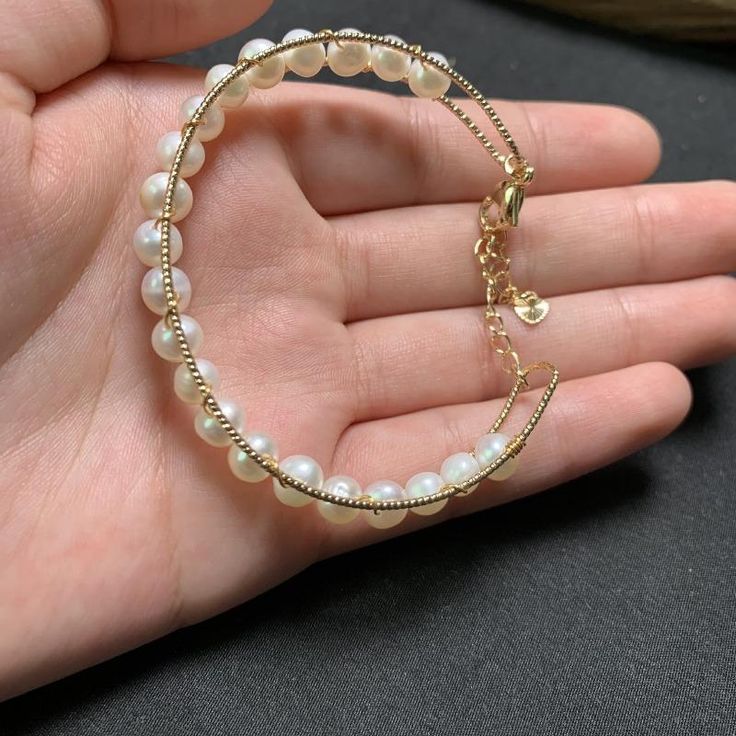 This beautiful Freshwater pearl bracelet ranges between 5-6mm in size and consists of beautiful and lustrous pearls in AAAA+ quality. All pearls in this bracelet are round and are strung with silk thread and double-knotted between each pearl. Known as the 'icon' of cultured pearls, Freshwater pearls have graced the necks, ears, fingers, and wrists of women for decades. Huge Tomato imports their Freshwater pearls from the Freshwater rs of Japan, grown in the Pinctada fucata oyster. All of our Fre Elegant Pearl Jewelry, Pearl Bangle Bracelet, Bracelet Elegant, Freshwater Pearl Jewelry, Pearl Bangle, Big Pearl, Wire Bangles, Freshwater Pearl Bracelet, Silk Thread