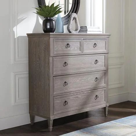 a wooden dresser sitting next to a window with a plant on top of it and a mirror above it