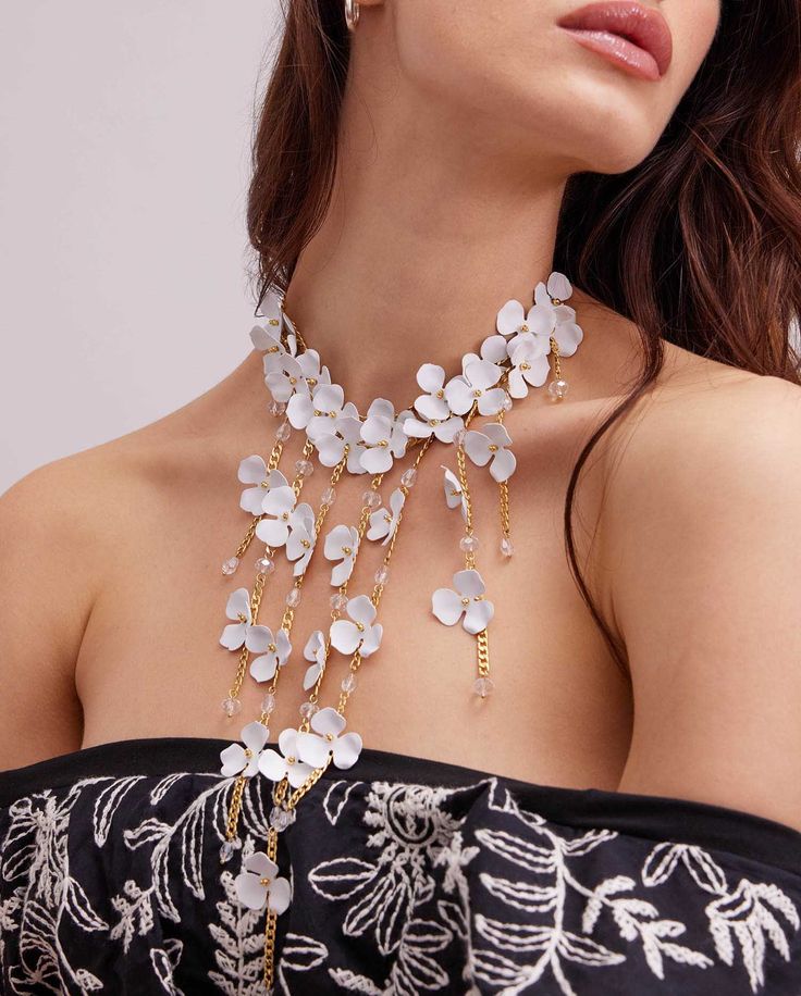 A gorgeous addition to any outfit, this PERLAYA is a delicate and thoughtful piece. A white flower is accented by gold chain. It is a bib style necklace with an easy on and off clasp closure. In the same theme you will find <a href="/DUNE" title="Link to DUNE" style="text-decoration: underline;">DUNE</a> <a href="/EGEA" title="Link to EGEA" style="text-decoration: underline;">EGEA</a>. White Flower Decorated Necklaces For Party, White Flower Decorated Jewelry For Parties, White Jewelry With Flower Decoration For Party, White Party Jewelry With Flower Decoration, Formal White Flower-shaped Necklaces, Formal White Flower-shaped Necklace, Formal White Flower Necklaces, Formal White Flower Shaped Necklace, Luxury White Flower Necklace