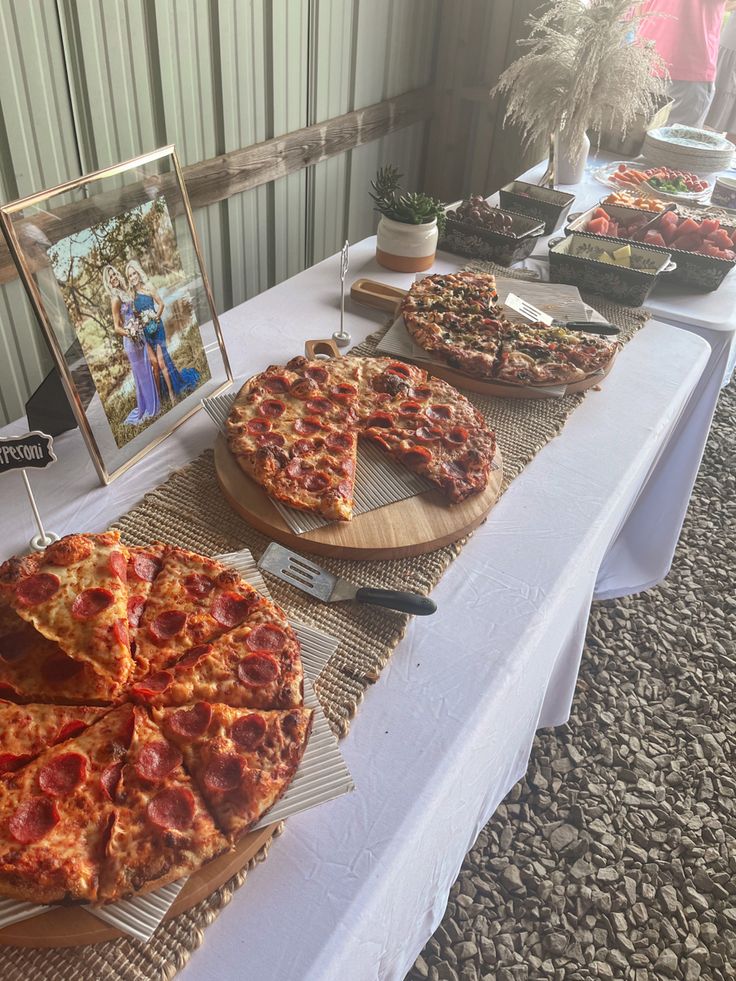 a table topped with pizza slices on top of wooden cutting boards