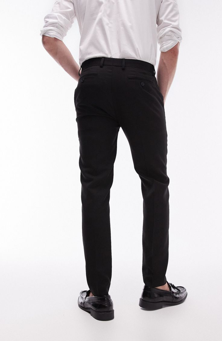 A lightly textured weave distinguishes neatly pressed trousers tailored in a skinny fit that looks smart whether worn with casual or formal styles. 30 1/2" inseam; 13" leg opening; 10 1/2" front rise; 14" back rise (size 32) Zip fly with hook-and-bar closure Front slant pockets; back welt pockets 64% polyester, 34% viscose, 2% elastane Dry clean Imported Semi-formal Stretch Elastane Bottoms, Stretch Elastane Pants For Semi-formal Occasions, Workwear Slim Fit Chinos With Belt Loops, Slim Fit Chinos With Belt Loops For Work, Fitted Black Straight Leg Chinos, Slim Fit Elastane Dress Pants For Semi-formal Occasions, Semi-formal Slim Fit Elastane Dress Pants, Tailored Black Straight Leg Chinos, Fitted Black Chinos For Work