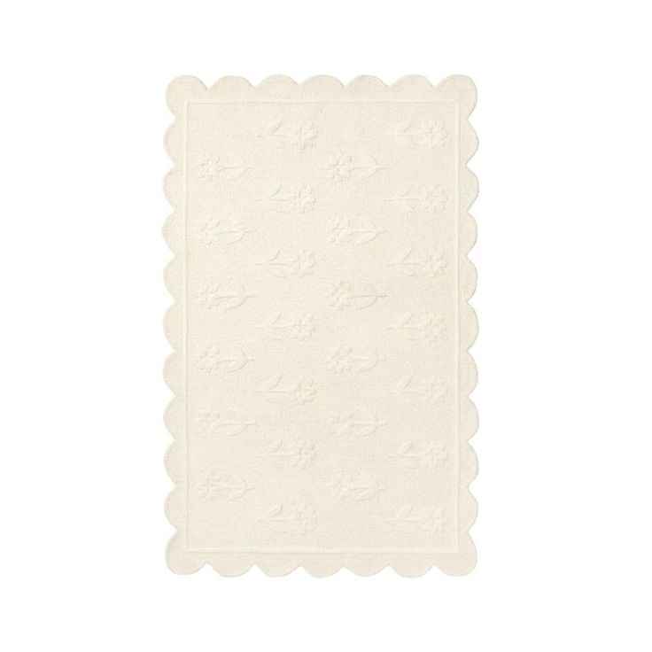 a white placemat with scalloped edges and stars on it, against a white background