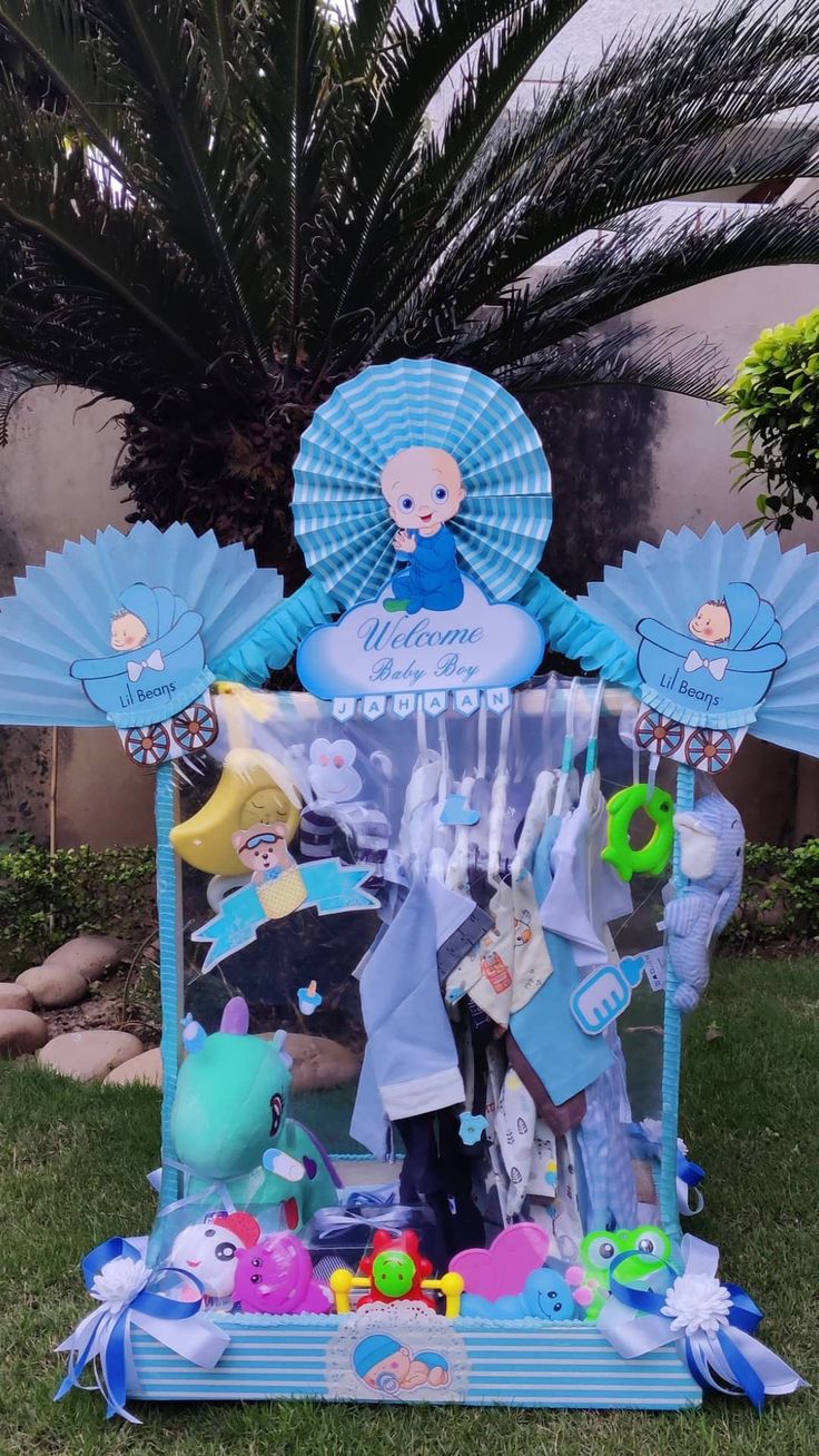 a blue and white display in the grass with an image of a baby on it