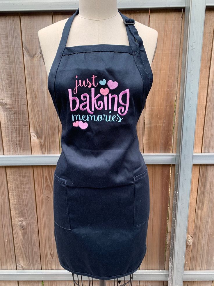 an apron that says just baking memories on the front, and pink hearts on the back