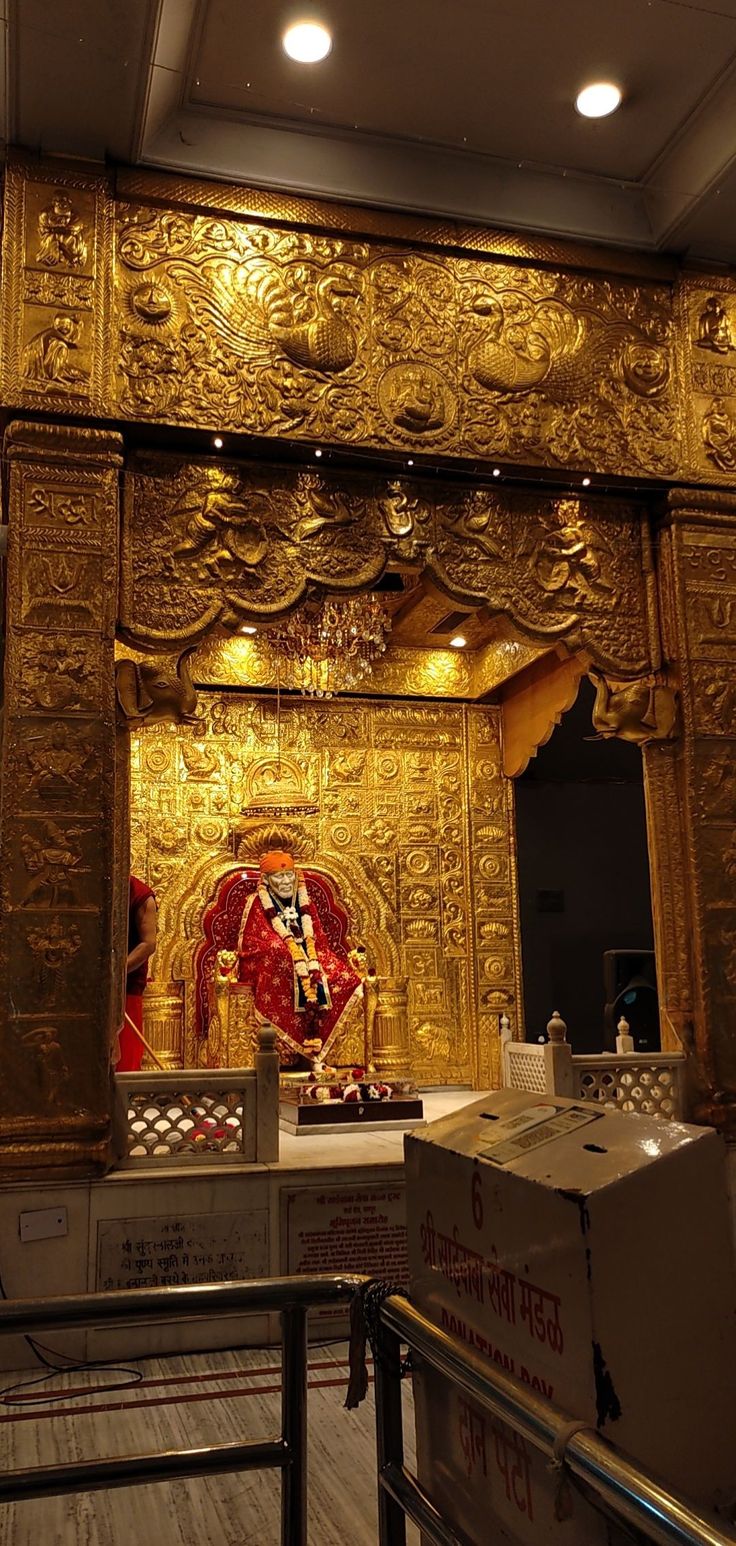 an ornate golden shrine in the middle of a room