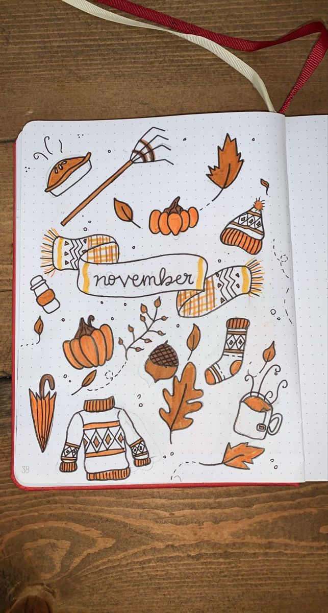 an open notebook with autumn doodles on it