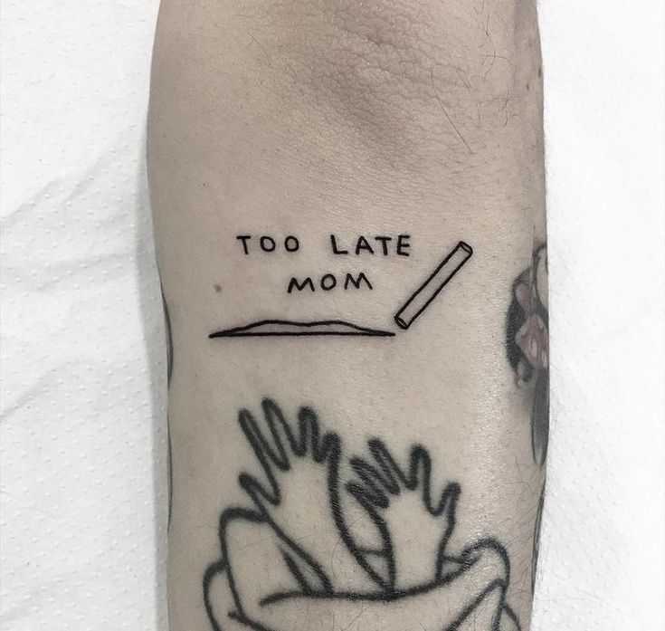 a black and white photo of a person's foot with the words too late mom on it