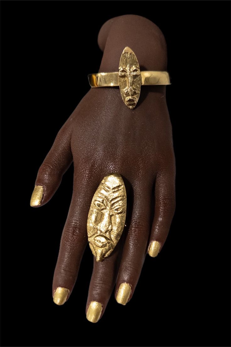 Expertly crafted from pure brass, this handmade Brass Mask Ring is the perfect accessory to add a touch of sophistication to any outfit. This versatile piece pairs beautifully with any brass bracelet, making it a must-have addition to your jewelry collection. Elevate your style with this timeless and elegant ring. Yellow Gold Open Ring Jewelry In Brass, Gold Brass Ring Jewelry, Bohemian Brass Bracelet Jewelry, Unique Hand Cast Bracelet Jewelry, Gold Brass Ring, Bohemian Brass Bracelet, Symbolic Hand Forged Ring Jewelry, Elegant Bronze Open Ring Jewelry, Metal Bangle Jewelry For Rituals