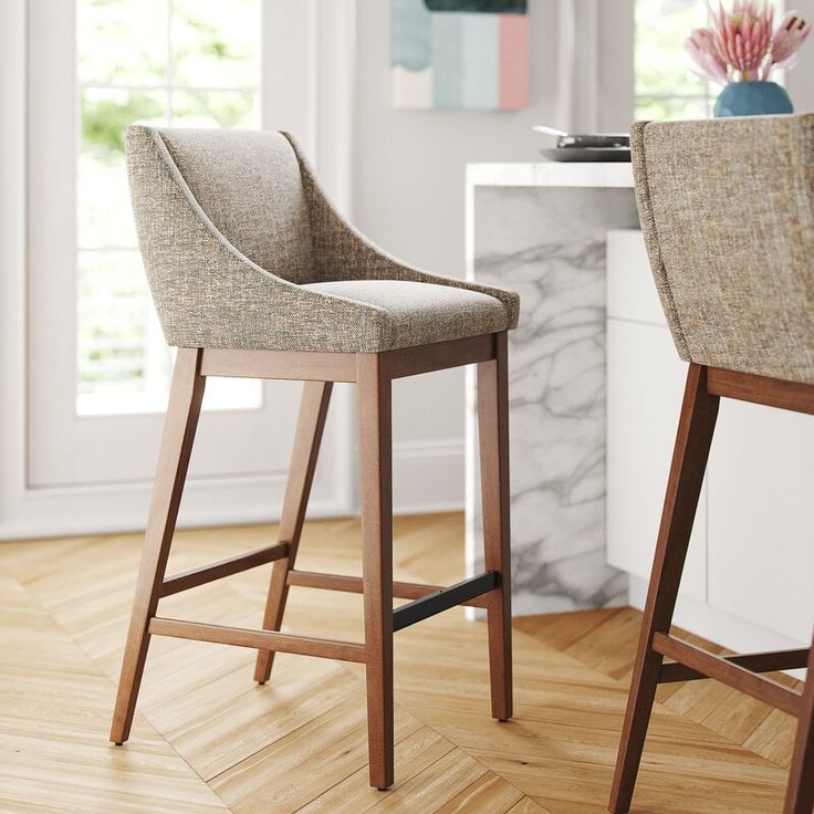 two chairs sitting next to each other on top of a hard wood floored floor