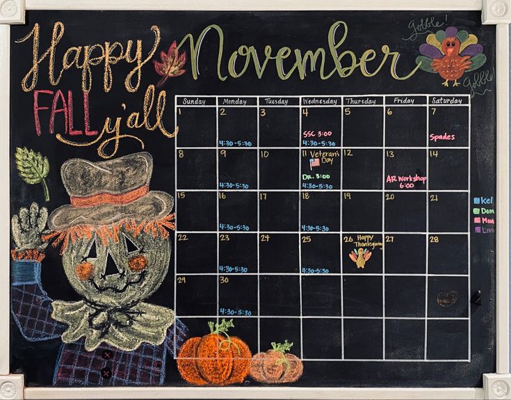 a chalkboard calendar with an image of a scarecrow and pumpkins on it