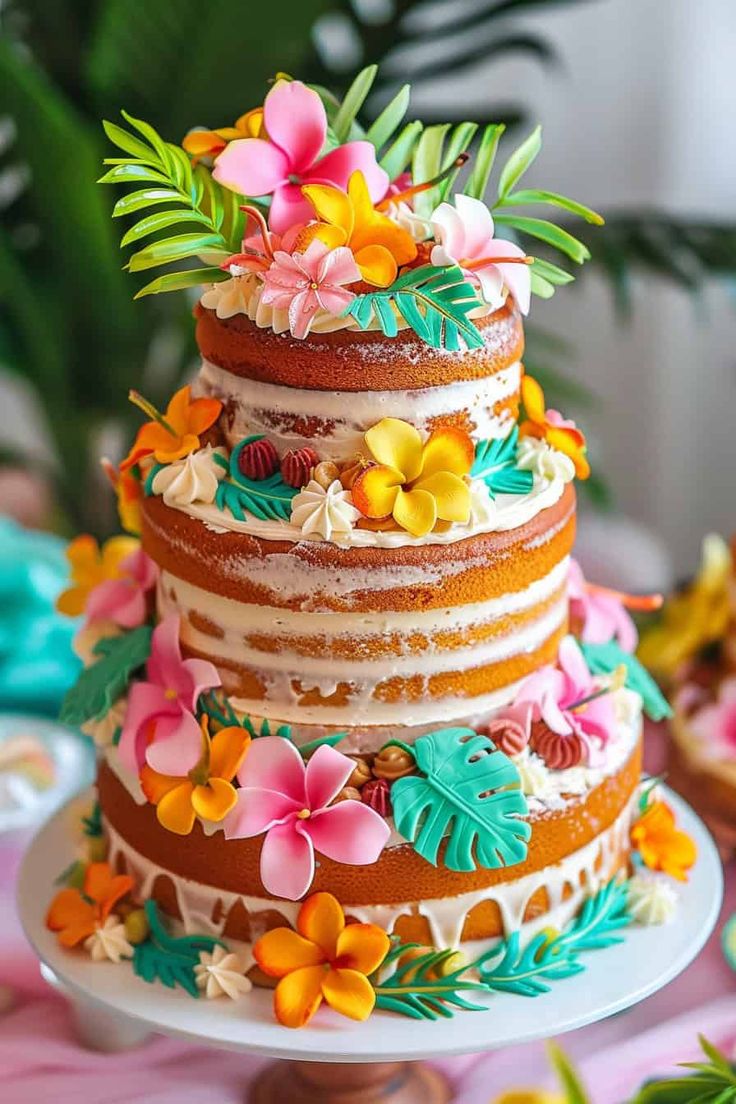 a multi layer cake decorated with flowers and leaves