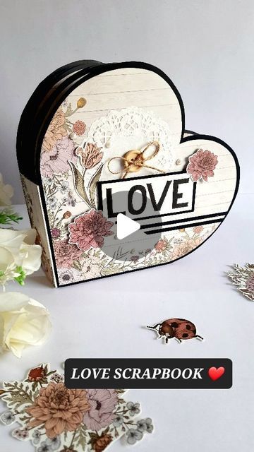 a love scrapbook with flowers and hearts on the cover, surrounded by stickers