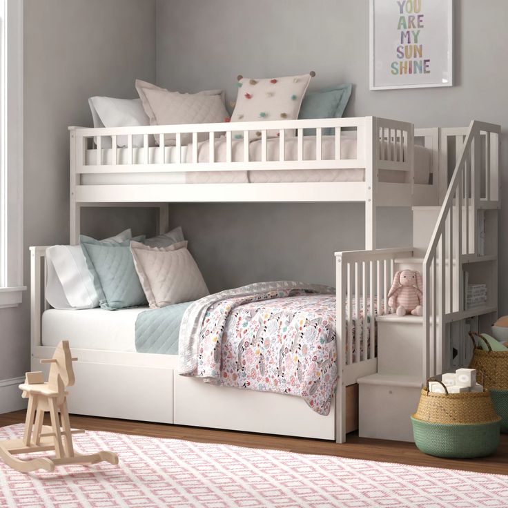 a white bunk bed sitting next to a window in a child's room on top of a wooden floor