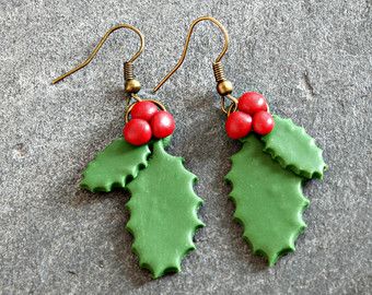 two green and red holly leaf shaped earrings