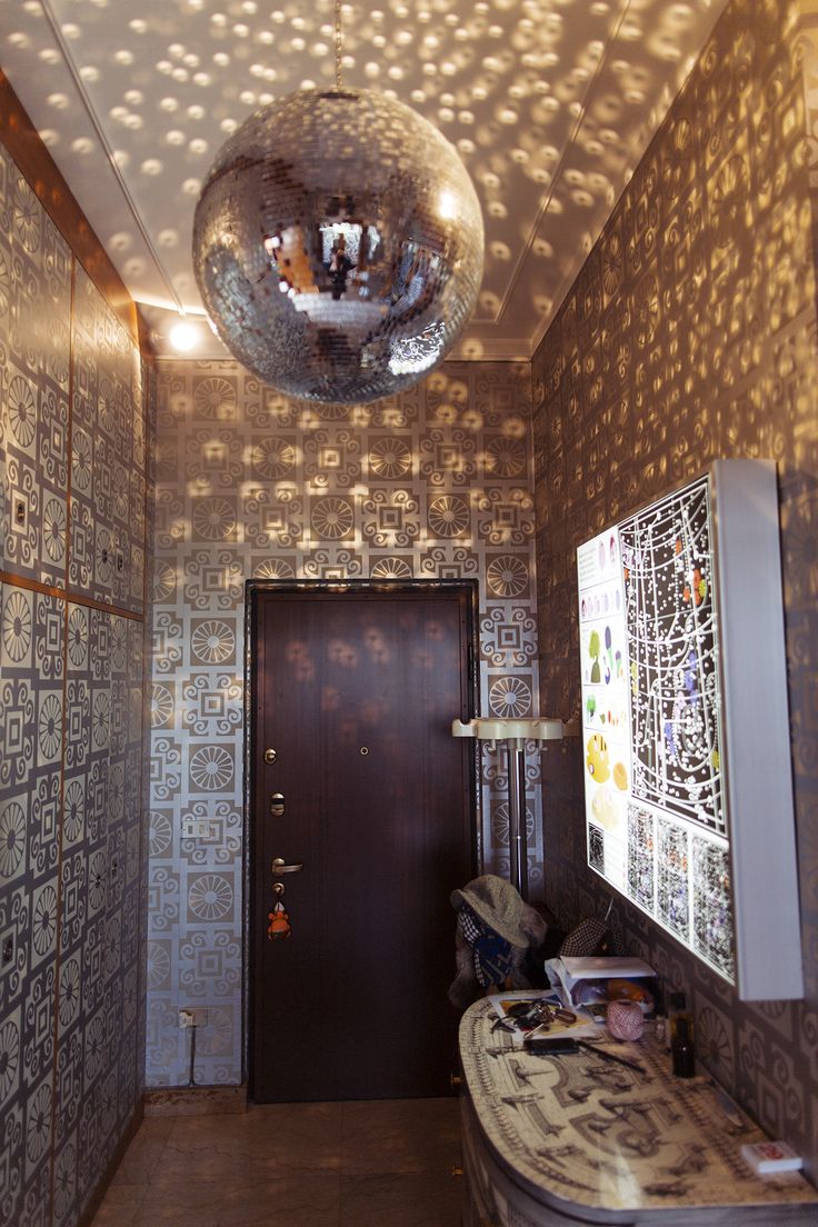 a mirror ball hanging from the ceiling in a room with tiled walls and flooring