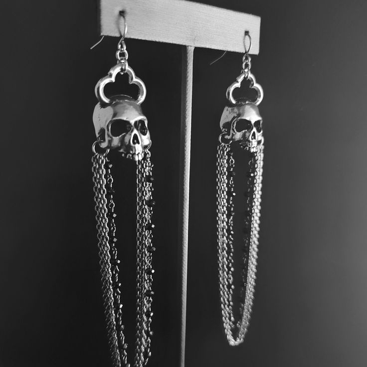 "Handcrafted & hand poured lead-free pewter skull with cathedral cross & black spinel rosary. Chandelier Skull is 1¼ L x ⅝\" W Overall length is 4.5\" Stud skull is ½\"W x ¾L They are hollowed as much as possible making them a comfortable weight." Halloween Metal Jewelry With Oxidized Finish, Halloween Oxidized Metal Jewelry, Nickel Free Gothic Pewter Jewelry, Gothic Silver Jewelry With Skull Print, Silver Skull Print Jewelry For Halloween, Silver Gothic Dangle Jewelry, Halloween Silver Jewelry With Skull Print, Gothic Sterling Silver Jewelry With Skull Print, Gothic Metal Skull Jewelry