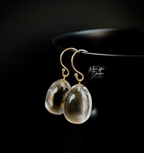 These are the ultimate everyday earrings! Just the thing to grab on the way out the door for that added sparkle and will go with everything in your wardrobe. These gems are truly amazing in person...like liquid pools of light. They are all natural, the finest specimens available, with the utmost luster and superb clarity. These 3 dimensional full egg shaped drops require the finest roughs to manufacture into these stunning beauties. As with this particular cut, the inclusions would be greatly ma Jewelry Closet, Gold Dangle Earrings, Etsy Bridesmaid Gifts, Egg Shape, Everyday Earrings, Gold Earrings Dangle, Etsy Earrings Dangle, Crystal Quartz, Rock Crystal