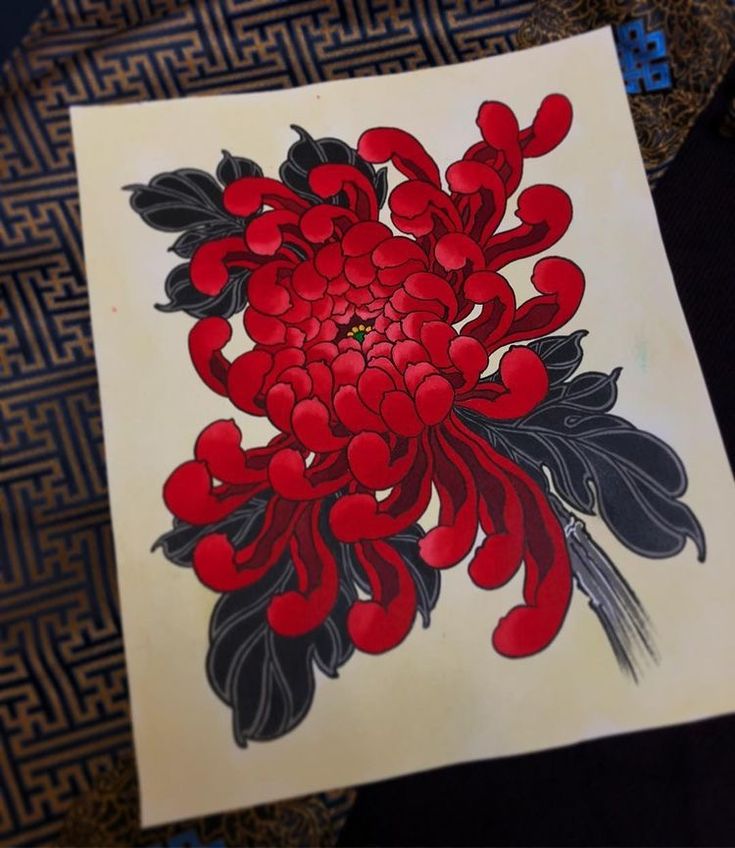 a piece of paper with red flowers on it