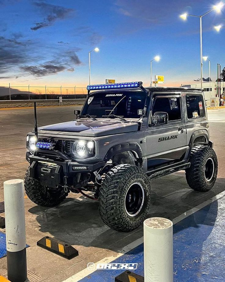 a gray truck parked on top of a parking lot