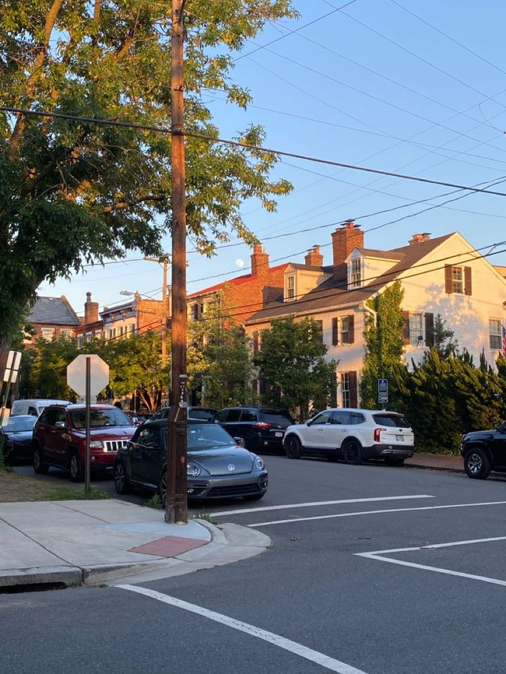 cars are parked on the street in front of houses